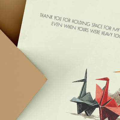 Card with origami cranes and a heartfelt message on a beige background